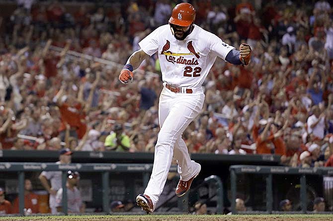 St. Louis Cardinals' Jason Heyward celebrates as he scores on a single by Tommy Pham during the fifth inning of a baseball game against the Washington Nationals on Wednesday, Sept. 2, 2015, in St. Louis. 