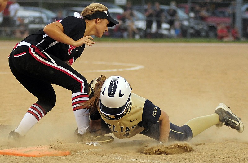 Helias baserunner Sophia Carr narrowly beats the tag but has her hand stepped on in the process as Jefferson City second baseman Taylor Dey covers first base on a pickoff attempt by Lady Jays' catcher Hannah Hirschvogel during Wednesday evening's game at Duensing Field.