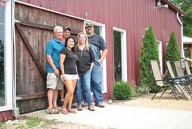 Celebrity pig farmer, Carl Blake, right, stands with Shawnee Bluff Vineyards staff, after discussing details of his upcoming hog roast as part of the venue's Fall Fest Concert Series. Staff include, from left, facilities director Jim Frederick, manager Dave Garrison, "Tiny" and Gail Griswold, vice president of operations.