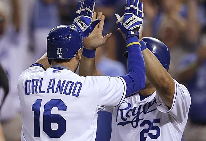 Kansas City Royals' Paulo Orlando (16) is congratulated by Kendrys Morales (25) after his two-run home run during the seventh inning of a baseball game against the Detroit Tigers at Kauffman Stadium in Kansas City, Mo., Thursday, Sept. 3, 2015.