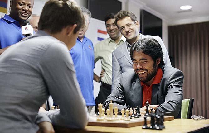 World Champion Magnus Carlsen and US Champion Hikaru Nakamura face off with Sinquefield Cup players cheering alongside them in a series of rapid and blitz exhibition games called Ultimate Moves at the Chess Club and Scholastics Center of St. Louis on September 3, 2015, in St. Louis. (Photo by Erin Stubblefield/Invision for Chess Club and Scholastics Center of St. Louis/AP Images)