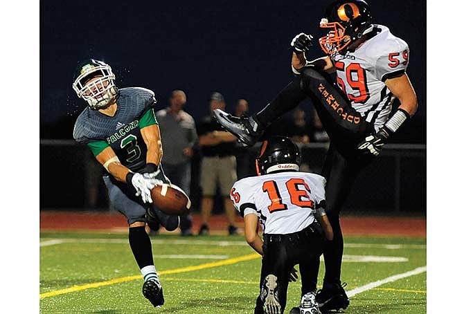 
Cody Alexander of Blair Oaks stretches out to block the extra point attempt by Owensville's Deric Rugen during last Friday night's game at the Falcon Athletic Complex in Wardsville.