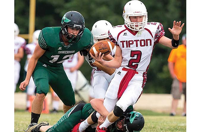 
North Callaway linebacker J.T. Higgins stalks Tipton quarterback Braiden Brownfield while an unidentfied Thunderbirds defender tries to drag down Brownfield last Friday in Kingdom City.