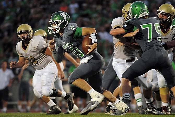 Blair Oaks quarterback Jordan Hair scrambles against Eldon on Friday at the Falcon Athletic Complex.