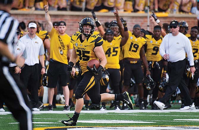 
Tyler Hunt of Missouri looks back as he runs toward the end zone on his way to a 78-yard touchdown reception during the fourth quarter of Saturday's game against Southeast Missouri State at Faurot Field in Columbia.