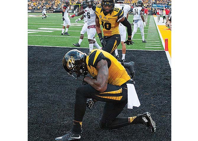 Missouri's J'Mon Moore celebrates a touchdown catch
against Southeast Missouri State as teammate Jason
Reese (10) comes to congratulate him during the first
half of Saturday's game in Columbia.