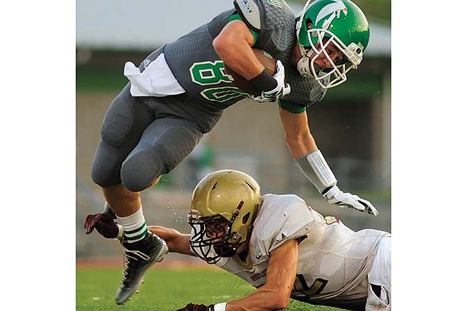 Blair Oaks receiver C.J. Closser tries to avoid the tackle attempt of Eldon's Levi Shinn during last Friday night's game in Wardsville.
