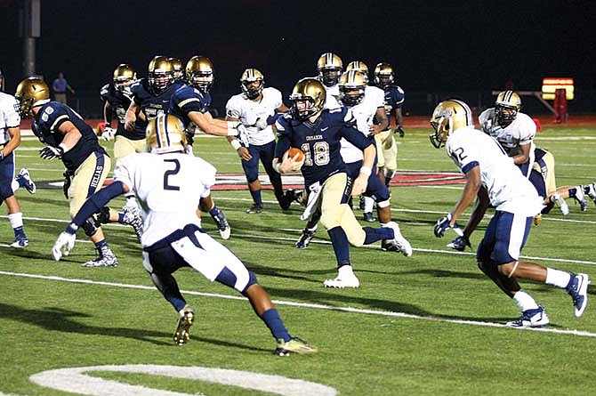
Helias quarterback Alex Faddoul runs with the football during last Friday night's game against Bishop Althoff at
Adkins Stadium