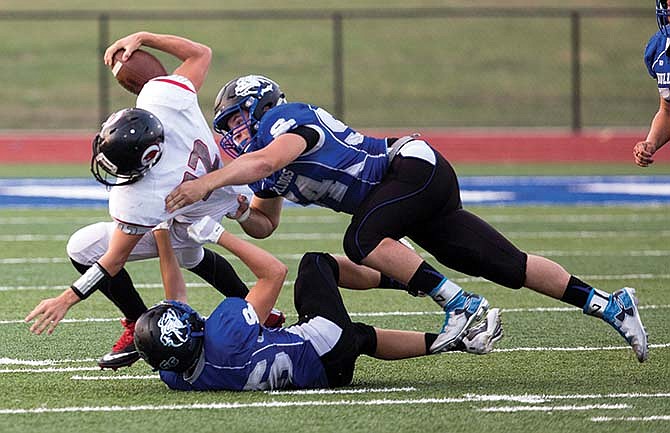 
South
Callaway
senior linebacker
Dillon
Stone
(top) and
an unidentified
teammate
take down
Clopton/
Elsberry
junior
quarterback
Stephen
Talbert last
week at
Mokane, Mo.