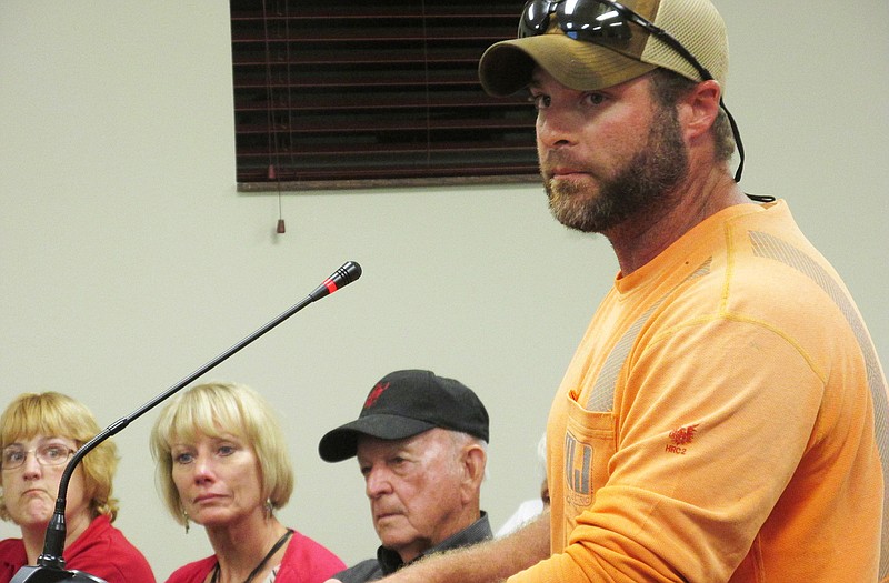 Community member Justin Cook fights to keep his voice from shaking as he recalls his experiences living in areas with low-income housing at the Holts Summit Board of Aldermen meeting Monday. He requested the board to reconsider the bill because he doesn't want his children to be exposed to the same experiences he had as a child.  