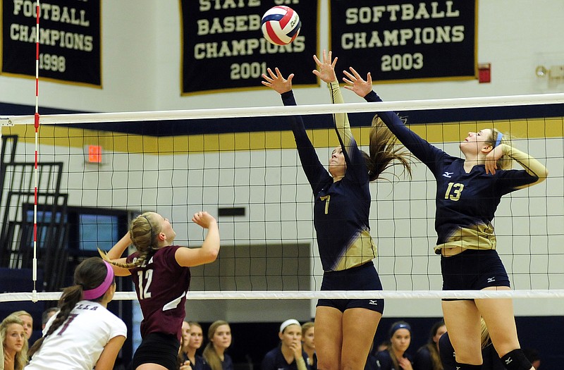 Helias' Erin Wyrick (7) and Suzie Kuensting (13) go up to block a shot at the net during Tuesday night's match against Rolla at Rackers Fieldhouse.