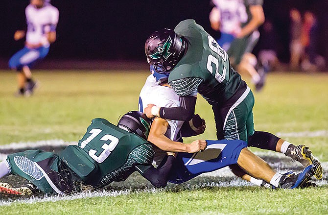 
North Callaway linebacker Adam Reno (right) and defensive back Chad
Maupin team up to bring down a Montgomery County runner in the Thunderbirds'
43-0 victory last Friday in Kingdom City, Mo.