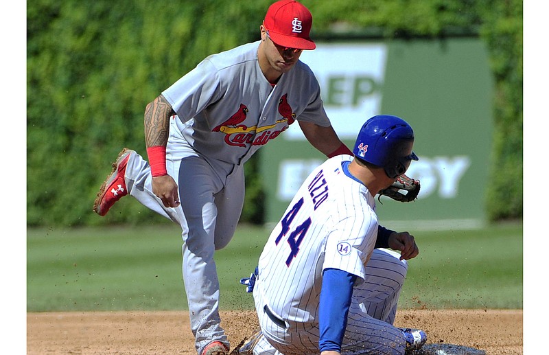 Chicago Cubs' Anthony Rizzo (44) is tagged out on a steal attempt by St. Louis Cardinals second baseman Kolten Wong, left, during the fifth inning of a baseball game, Saturday, Sept. 19, 2015, in Chicago.