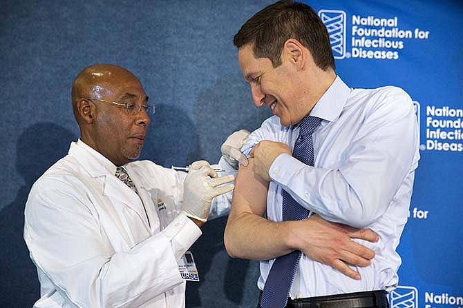 Centers for Disease Control and Prevention Director Dr. Tom Frieden, right, receives a flu shot from nurse B.K. Morris during an event about the flu vaccine, Thursday, Sept. 17, 2015, at the National Press Club in Washington. It's time for flu shots again, and health officials expect to avoid a repeat of the misery last winter, when immunizations weren't a good match for a nasty surprise strain.