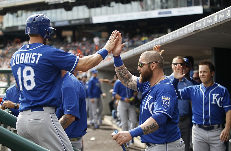 Kansas City Royals' Ben Zobrist (18) is congratulated by Jonny Gomes after scoring against the Detroit Tigers during the first inning of a baseball game at Comerica Park Sunday, Sept. 20, 2015, in Detroit. 