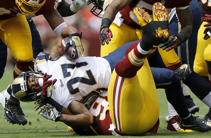 St. Louis Rams running back Tre Mason (27) is stopped by Washington Redskins defensive tackle Ricky Jean Francois (99) during the first half of an NFL football game in Landover, Md., Sunday, Sept. 20, 2015.