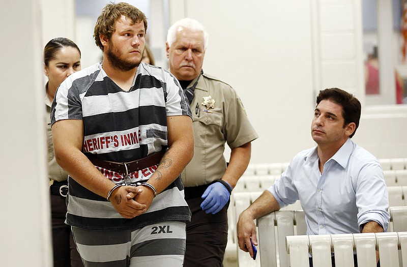 Leslie Allen Merritt Jr., makes his way to appear before a judge at the Maricopa County Sheriff's Office on Saturday in Phoenix. The landscaper is the suspect in a series of Phoenix freeway shootings and was arrested Friday after trying to sell a gun at a pawn shop.  
