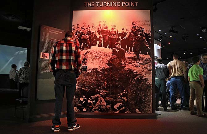 A group of students from Anchor Academy near Sikeston tour the Holocaust Museum and Learning Center in St. Louis. As the museum celebrates its 20th anniversary, it's looking at ways to continue sharing the firsthand accounts of Holocaust survivors who have since died. Of the 300 survivors initially estimated to live in the area, fewer than 100 are living today. (Christian Gooden/St. Louis Post-Dispatch via AP)