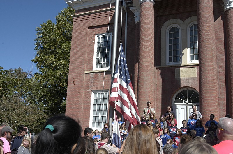 At the Ozark Ham and Turkey Festival, Boy Scout Troop 120 raises the flag at the Moniteau County Courthouse, after which the Pledge of Allegiance was recited.