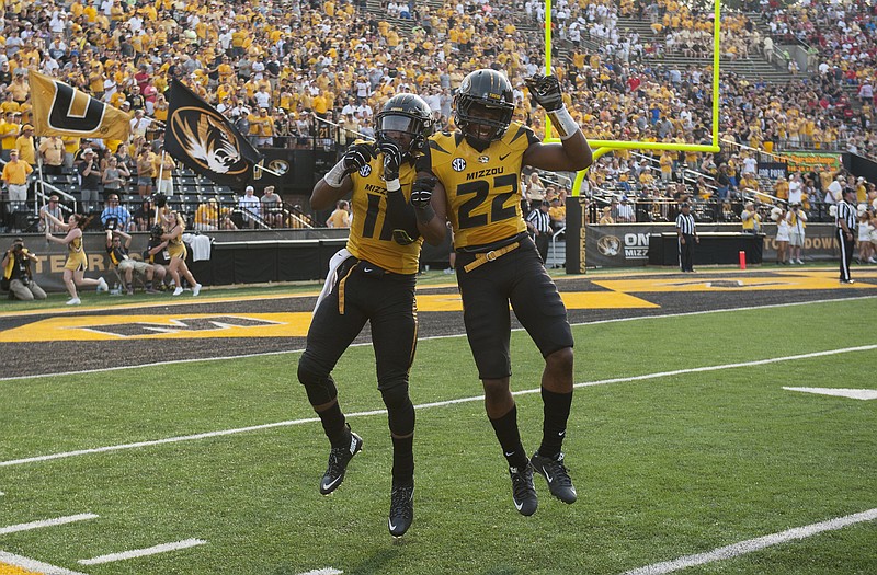 Missouri's Aarion Penton, left, celebrates with teammate Anthony Sherrils, right, after Penton scored a touchdown during the third quarter of a game against Southeast Missouri State Saturday, Sept. 5, 2015 in Columbia.