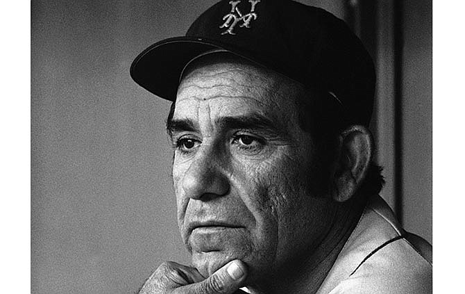 This Sept. 21, 1973, file photo shows Yogi Berra, manager of the New York Mets, watching his team work during a game in Philadelphia. Berra, the Yankees Hall of Fame catcher has died. He was 90. 