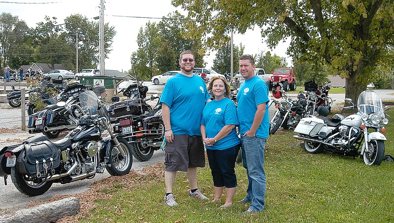 Mary Rush, center, with sons Daniel, left, and Derek, right, before the Guy Rush Memorial Motorcycle Poker Run is to begin on Saturday, Sept. 12. The event began at the Lucky Dog Pub and Grub, Jamestown.