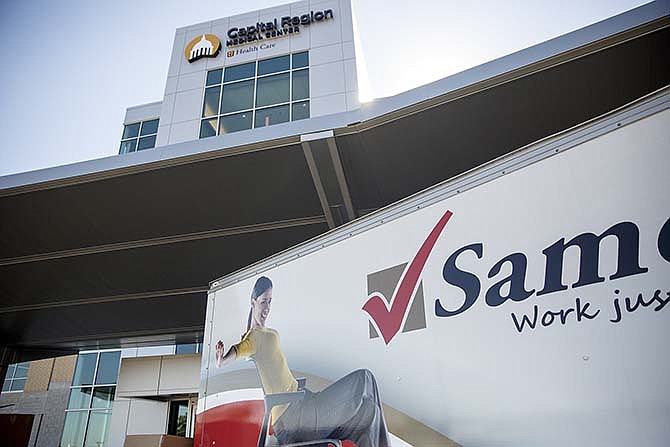 An office furniture truck sits outside the new Capital Region Medical Center expansion wing Thursday afternoon as crews work diligently to furnish the hospitals new outpatient center in advance of Monday's opening. 