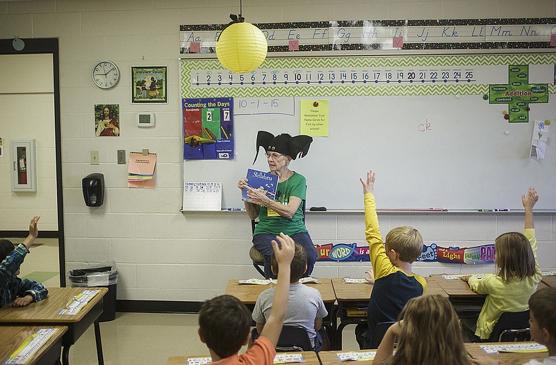 Loretta Broker dons a bat hat while reading Stella Luna to a group of first graders at St. Martins School in St. Martins. For years Broker, who has two grandchildren at the school, has had a fondness for entertaining children and the elderly. 