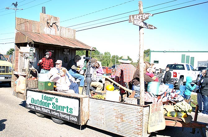 Edgar's Outdoors Sports won first place in the
commercial division of Versailles' Apple Festival parade
for its creative, old-fashioned float.
