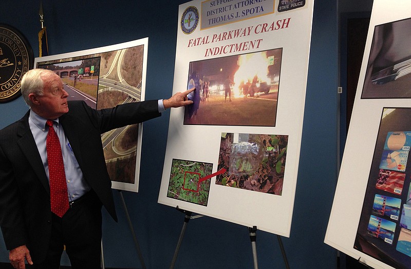 Suffolk County District Attorney Thomas J. Spota points to a photograph of the aftermath of a deadly automobile accident on New Yorks Long Island, during a news conference in Happague, N.Y. 