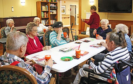 Residents of Fulton Presbyterian Manor enjoy Root beer floats after placing informational cards inside bags containing pillowcases for Ryan's Case for Smiles Monday. Case for Smiles has visited Presbyterian Manor for help with creating and packaging the pillowcases in the past.