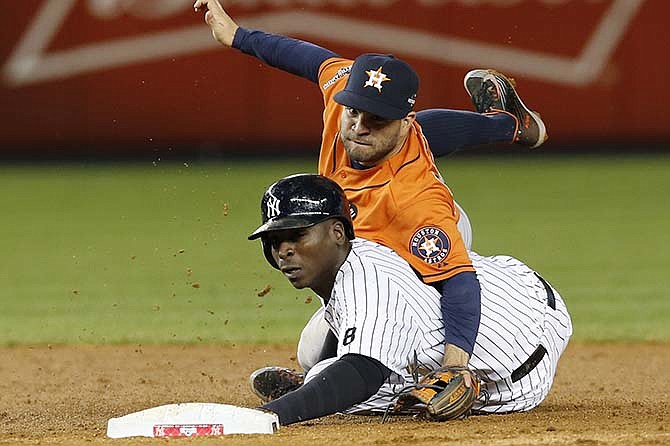 Houston Astros second baseman Jose Altuve, above, gets tangled up with New York Yankees Didi Gregorius after tagging him out on a fielder's choice during the sixth inning of the American League wild card baseball game at Yankee Stadium in New York, Tuesday, Oct. 6, 2015.