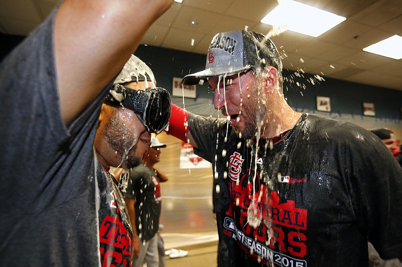 Cardinal teammates Jhonny Peralta (left) and Adam Wainwright celebrate clinching the National League Central Division last week in Pittsburgh.