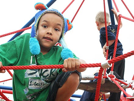 Kegan Young, 6, begins his climb to the top of the new "play web" at Memorial Park. The equipment was erected in memory of "Super" Sam Santhuff, a 6-year-old Fulton boy who died after his cancer returned a second time Sept. 2014. Members of the community joined the Santhuff family, the Callaway Chamber of Commerce and the Boyd and Boyd Relay for Life team for the unveiling ceremony.