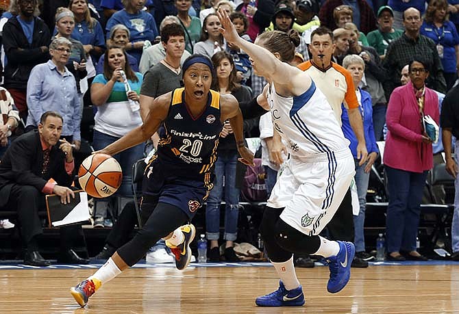 Indiana Fever guard Briann January (20) drives on Minnesota Lynx guard Lindsay Whalen in the first half of Game 2 of the WNBA basketball finals, Tuesday, Oct. 6, 2015, in Minneapolis. 