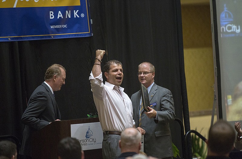 Coffee Zone owner Taisir Yanis cheers after winning the Small Business of the Year Award at the Jefferson City Area Chamber of Commerce's annual Small Business Showcase at Capitol Plaza Hotel.