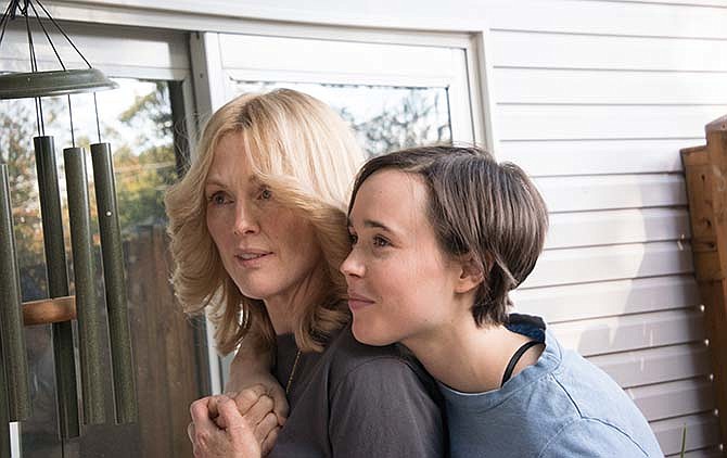 In this image released by Lionsgate, Julianne Moore, left, and Ellen Page appear in a scene from "Freeheld."
