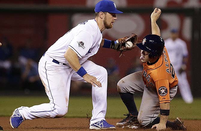 Houston Astros' Jose Altuve, right, is tagged out by Kansas City Royals second baseman Ben Zobrist, left, while trying to steal second base during the fifth inning in Game 1 of baseball's American League Division Series, Thursday, Oct. 8, 2015, in Kansas City, Mo. 
