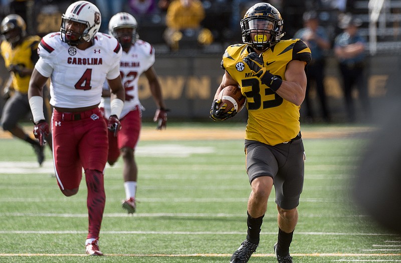 Missouri's Cam Hilton, right, returns a punt in front of South Carolina's Jalen Christian, left, during the first quarter of an NCAA college football game Saturday, Oct. 3, 2015, in Columbia, Mo.