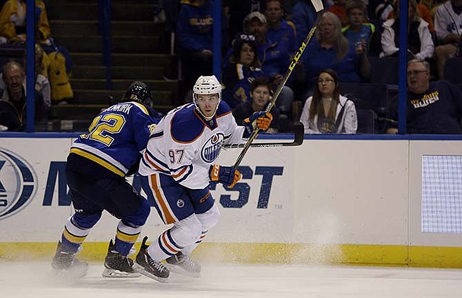 Edmonton Oilers' Connor McDavid, right, skates past St. Louis Blues' Kevin Shattenkirk during the first period of an NHL hockey game Thursday, Oct. 8, 2015, in St. Louis. 