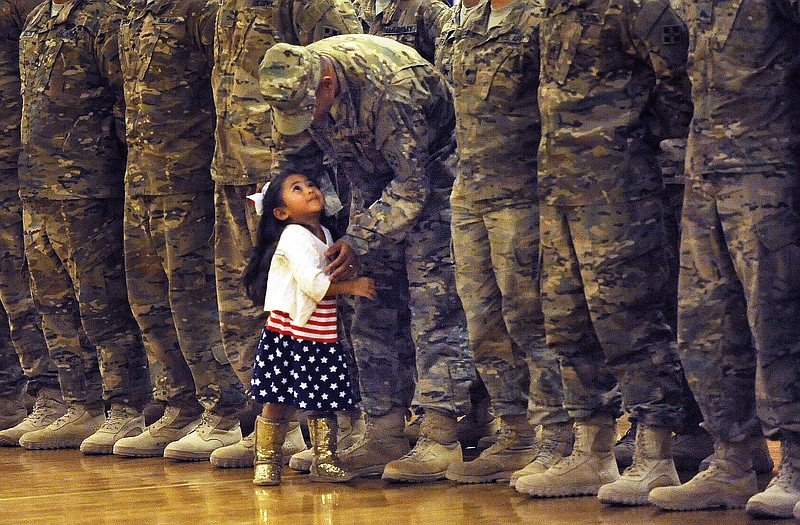 Karas Ogelsby had such a hard time waiting for the dismissal of the troops during a homecoming she broke away from her mom and ran to her father, Lt. Daniel Ogelsby at at Ft. Carson, Colo. Lt. Ogelsby gave her hug and gently sent her back to her mom until the end of the ceremony. 