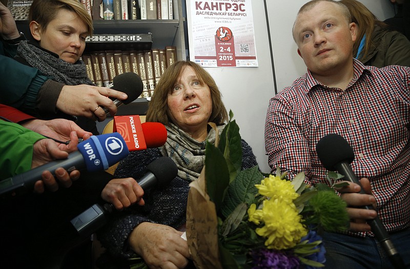 Belarusian journalist and writer Svetlana Alexievich, the 2015 Nobel literature winner, center, is surrounded after her news conference in Minsk, Belarus.
