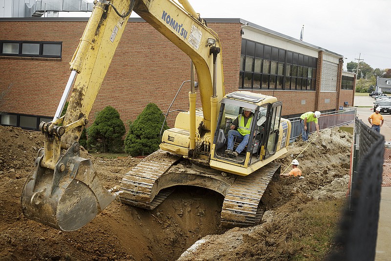 An excavation crew digs a trench for a storm drain next to Helias High School Friday as part of the groundwork for the new expansion project at Helias.