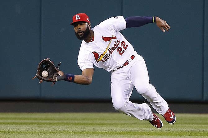 St. Louis Cardinals right fielder Jason Heyward catches a ball hit by Chicago Cubs' Addison Russell during the third inning of Game 1 in baseball's National League Division Series, Friday, Oct. 9, 2015, in St. Louis.
