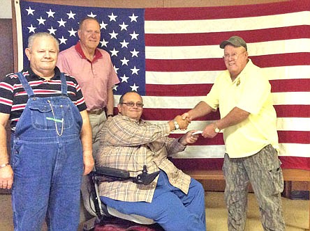 Members of VFW Post 2657 present Jeremy Polston with a check for $1,000. The funds will assist Polston and his wife Erica whose son, Gabriel, is recovering at a Ronald McDonald House in St. Louis after a bone marrow transplant.