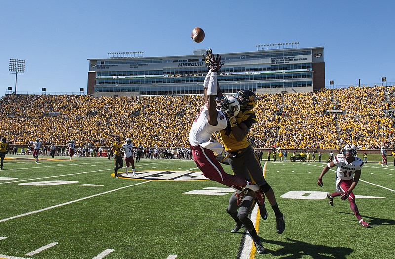 Missouri defensive back Kenya Dennis, right, breaks up a pass intended for South Carolina wide receiver Jerad Washington, left, during the third quarter of an NCAA college football game, Saturday, Oct. 3, 2015, in Columbia, Mo.