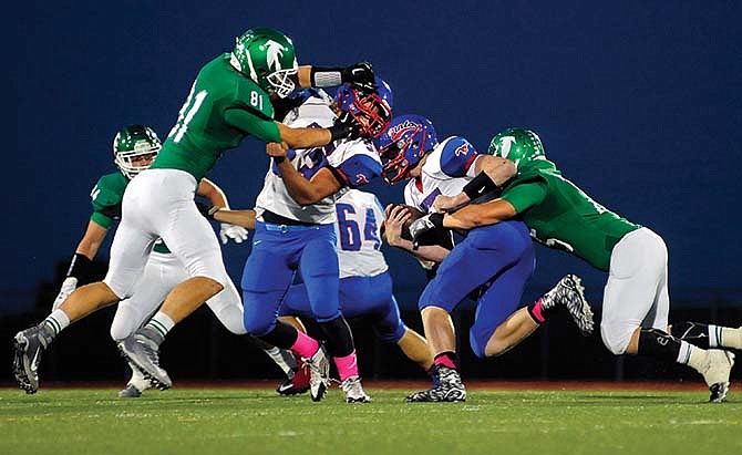 Kris Wilson/News Tribune
Tanner
Lueckenhoff
of
Blair Oaks
makes a
tackle at
the line of
scrimmage
during
last Friday
night's win
against
California
at the Falcon
Athletic
Complex in
Wardsville.