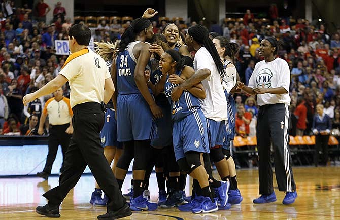 Minnesota Lynx forward Maya Moore celebrates with her teammates after scoring a game winning three-pointer in the second half of Game 3 of the WNBA Finals basketball series against the Indiana Fever, Friday, Oct. 9, 2015, in Indianapolis. Lynx won 80-77.