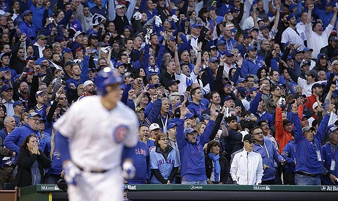 Fans cheer as Chicago Cubs' Anthony Rizzo (44) hits a home run against the St. Louis Cardinals during the sixth inning of Game 4 in baseball's National League Division Series, Tuesday, Oct. 13, 2015, in Chicago. 