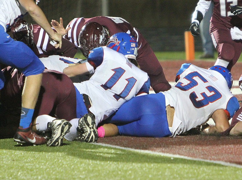 Jacob Wolken pushes ahead for a 1-yard quarterback sneak touchdown. Wolken had three rushing touchdowns in Friday night's game.